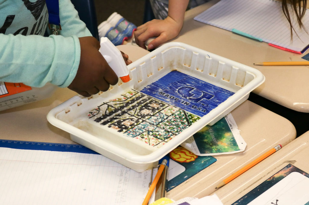 Painted plastic paint trays served as simulated miniature watersheds.