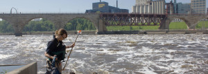 An MWMO staff person conducts water quality monitoring in the Mississippi River.