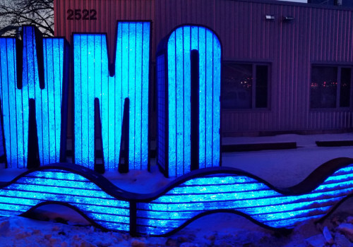 The lighted MWMO sign sculpture at night.