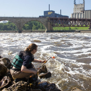 MWMO staff collecting water samples from the Mississippi River.