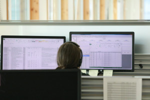 An MWMO monitoring team staff member working at two computer monitors.