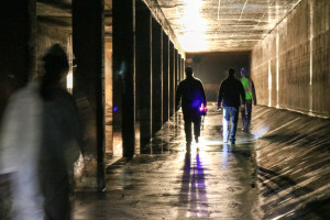 Workers walking through an underground stormwater storage tank.