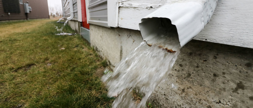 Runoff spewing from a downspout.