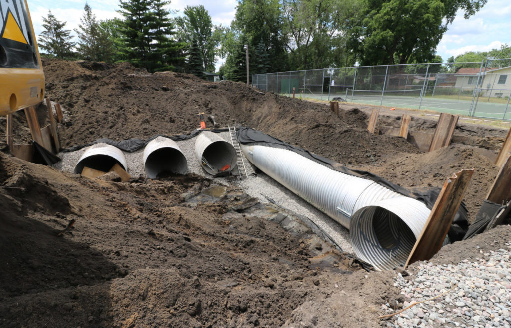 Perforated pipes partially buried.