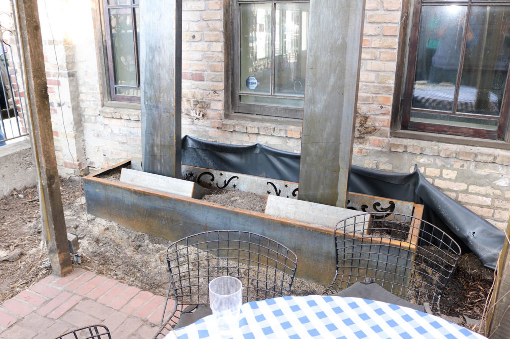 A view of the bottom of the conveyance structure during construction. Underground pipes carry the runoff to a pair of dry wells.