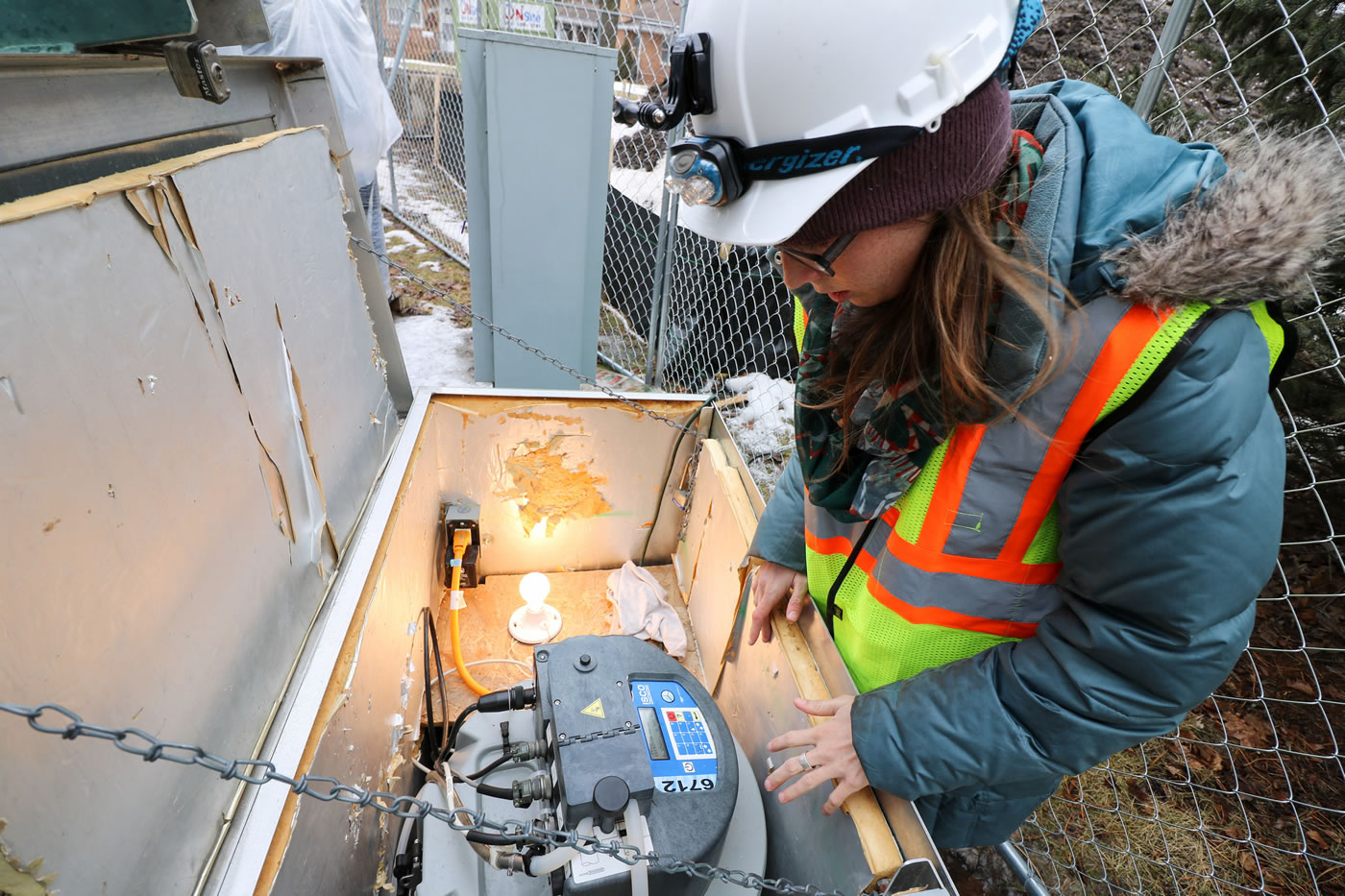 MWMO Environmental Specialist Brittany Faust conducts maintenance on automatic water sampling equipment in February 2016.