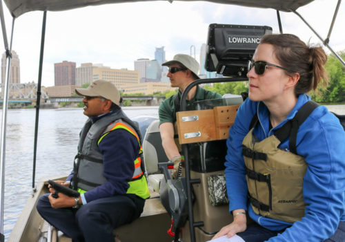 MWMO monitoring team members scout for erosion along the Nicollet Island shoreline.
