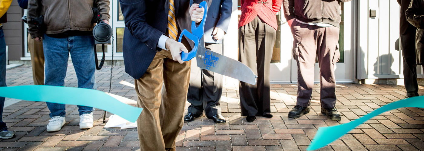 cutting a ribbon at a ceremony