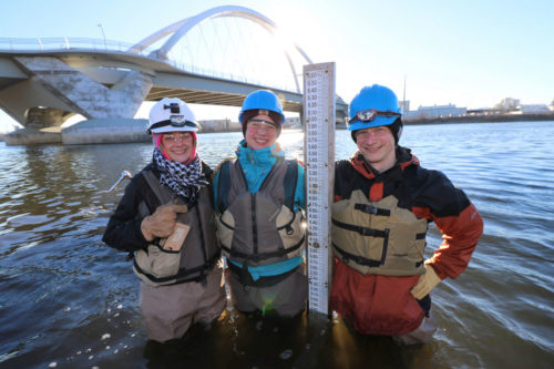 Monitoring team staff pose after installing a new staff gauge in the river in March 2016.