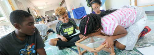 Children studying a watershed map.