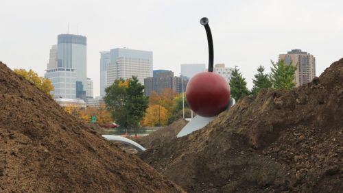 The Spoonbridge and Cherry sculpture, surrounded by mounds of dirt.
