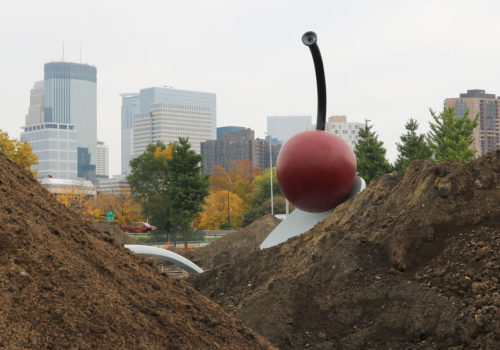 The Spoonbridge and Cherry sculpture, surrounded by mounds of dirt.
