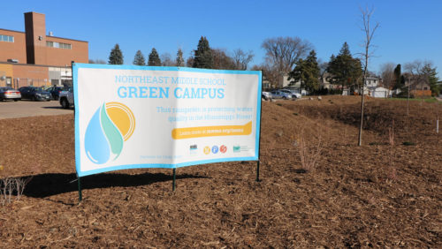 A sign banner advertising the new Northeast Middle School Green Campus.