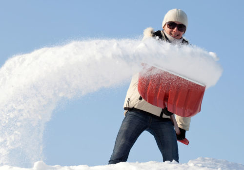 Woman shoveling snow.