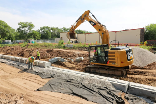 Workers installing a retaining wall at the Harbor Freight Pond in June 2016.