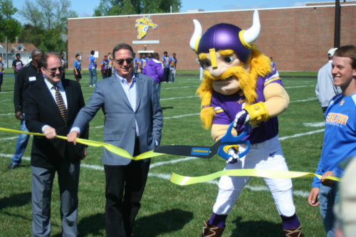 MWMO Board Chair Kevin Reich (left) and Minnesota Vikings Executive Vice-President Lester Bagley (center) at the ribbon cutting for the school’s new athletic field in 2015.