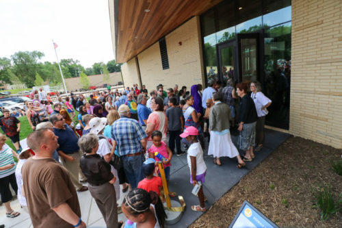 A crowd gathers at the entrance of the new library.