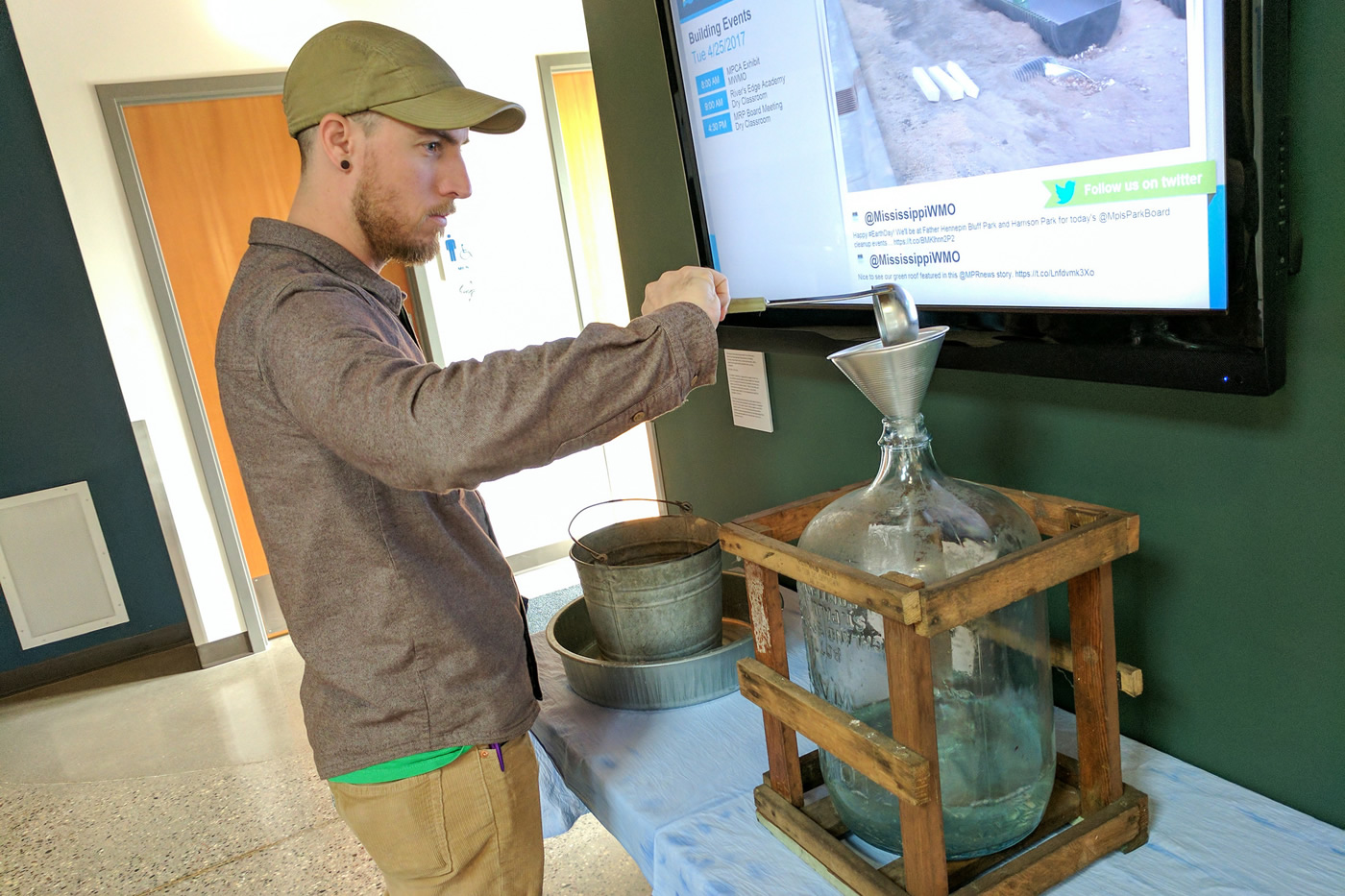 Ladling water into a jug.