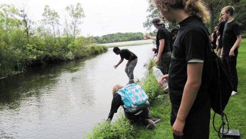 Students collecting river water samples.