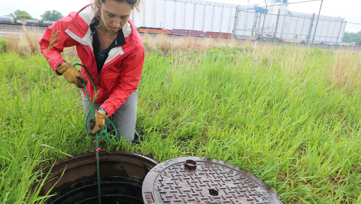 Monitoring team member draws stormwater up from a stormdrain at a monitoring site in Fridley on May 17, 2017. 