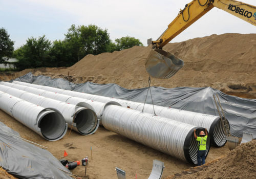 Workers assemble the storage tanks at Edison High School.