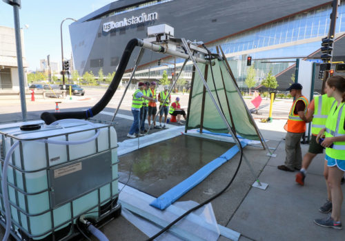 A rain simulator in use near U.S. Bank Stadium.