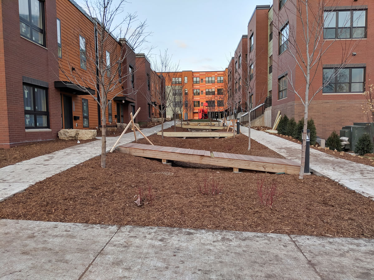 A linear raingarden runs the length between the two buildings at EcoVillage Apartments.