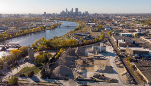 An aerial view of Cemstone, with the Mississippi River and downtown Minneapolis in the background.