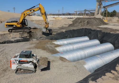 Workers installing the stormwater reuse tanks at Cemstone on April 26, 2018.