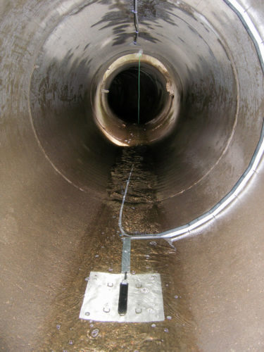 Typical area/velocity sensor (black rectangle) and cable and tubing configuration in a monitored stormwater tunnel.