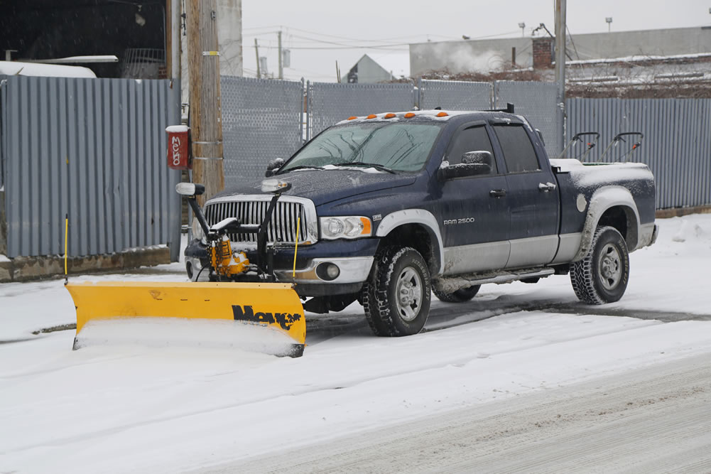 Pickup truck outfitted with snow plow.