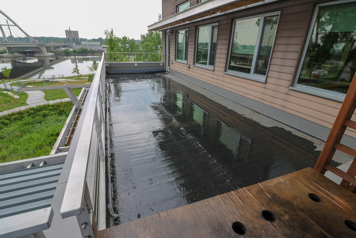 A standard blacktop roof sits side-by-side with the green roof.