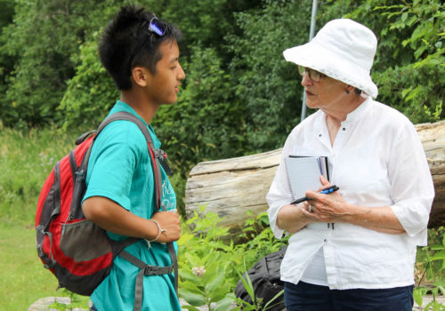 Ruth visiting with a Mississippi River Green Team member in the field.