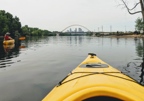 First-person view from a Paddle Share kayak, with downtown Minneapolis in the background.