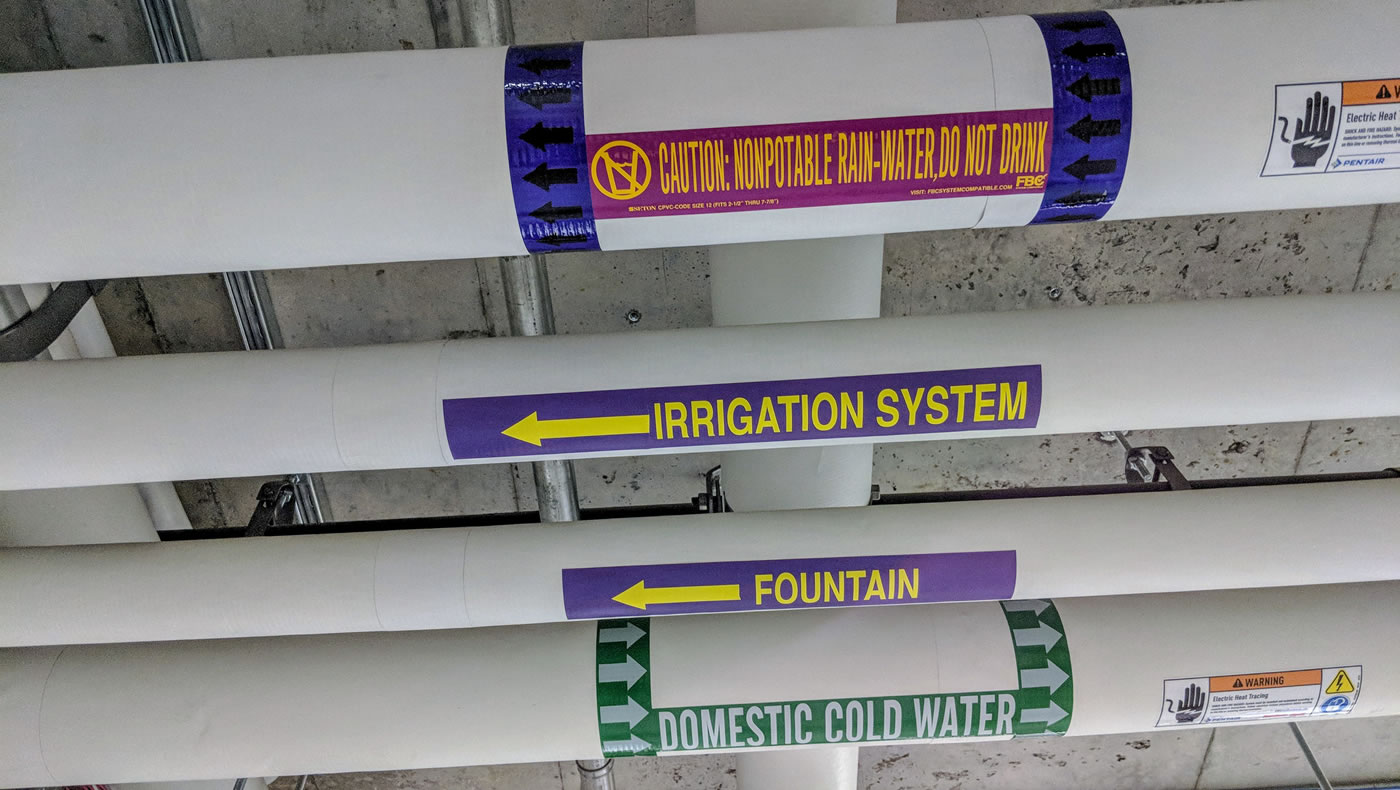 Pipes with labels that show different types of water flowing through them.