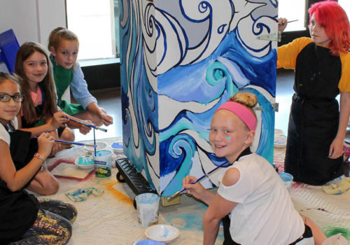 Children painting a mural.