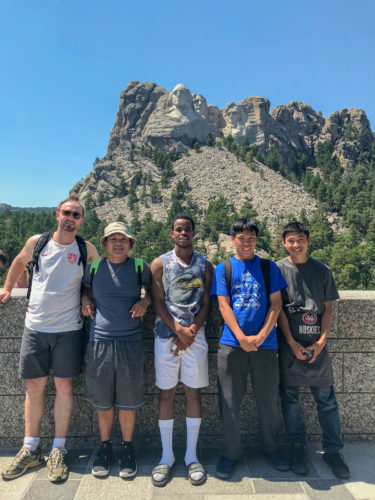 Five young men posing in front of Mount Rushmore. (Photo: The Nature Conservancy)