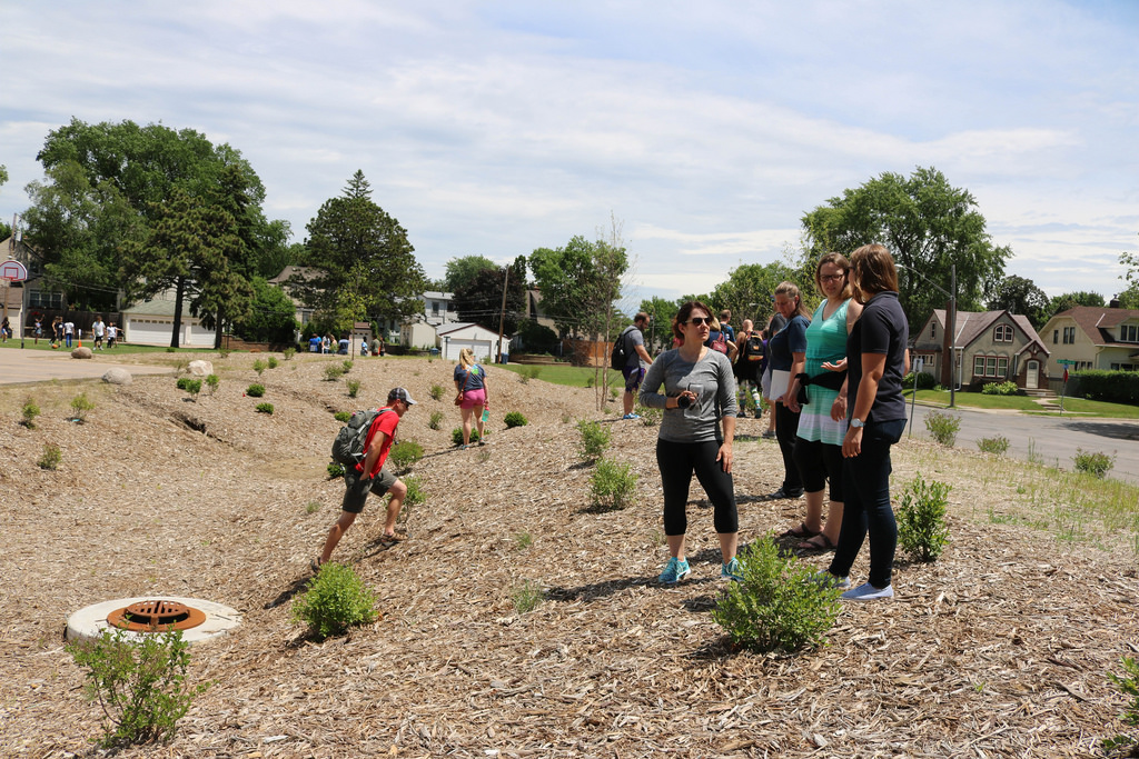 Students from the University of St. Thomas visit the new raingarden at Northeast Middle School with MWMO staff. The students are teachers learning how to integrate STEM topics into their classrooms.