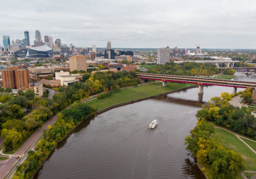 An aerial view of the Mississippi River, with downtown Minneapolis in the background.