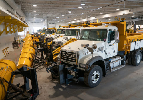 City of Fridley snow plow trucks in a garage.