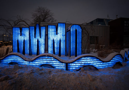 MWMO sign sculpture at night.