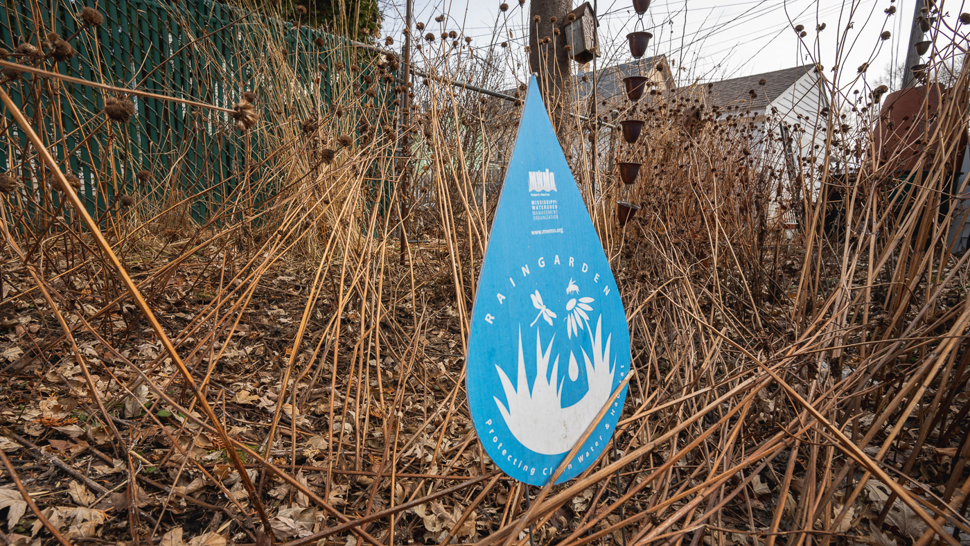 An MWMO raingarden sign in a raingarden in late winter.