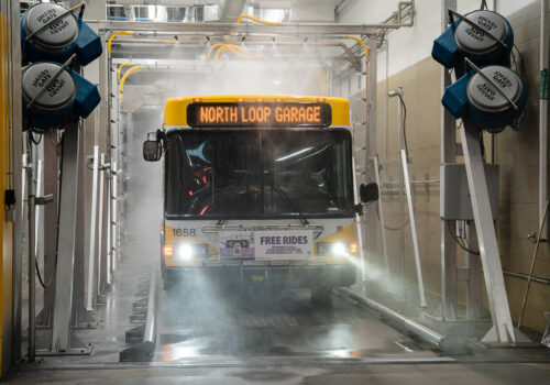 A bus is rinsed off with recycled stormwater.