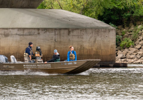 The MWMO boat cruises on the Mississippi River.