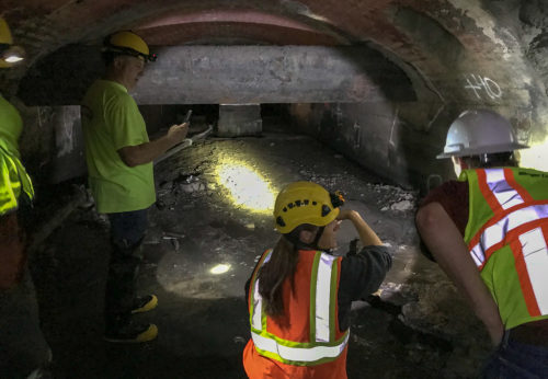 Workers examine conditions in Old Bassett Creek Tunnel.
