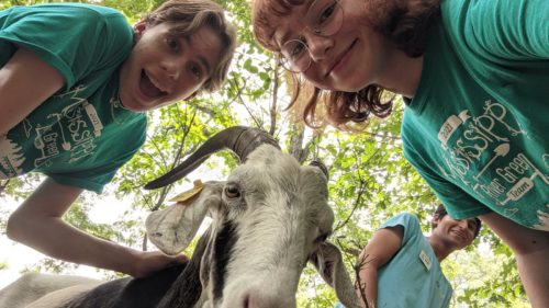 Mississippi River Green Team members with a goat.