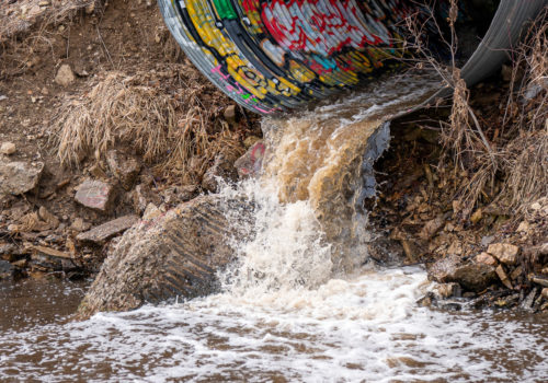 Runoff gushes from a stormwater outfall in the Mississippi River Gorge.