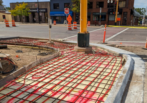 Exposed piping of a sidewalk snowmelt system.