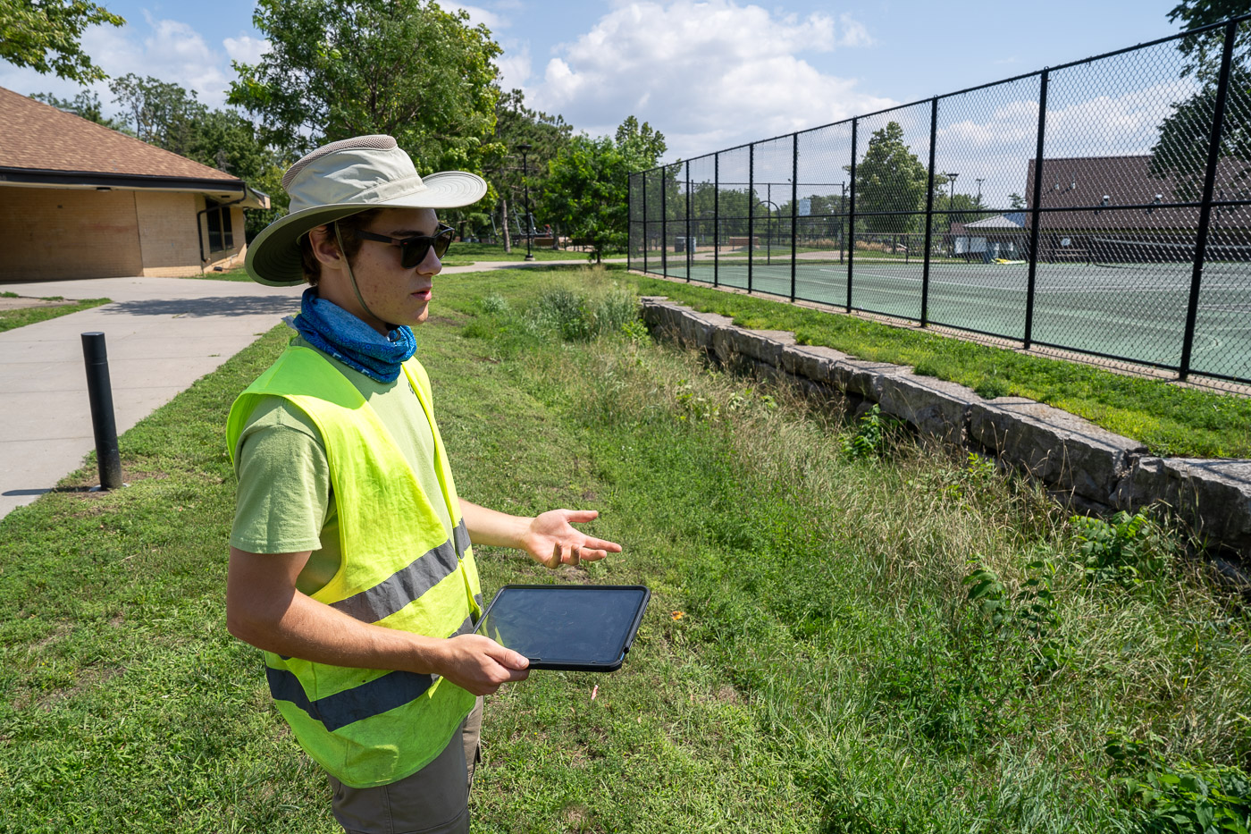 GRIIT member Noah Sullivan inspects a stormwater infiltration basin at Webber Park in North Minneapolis.