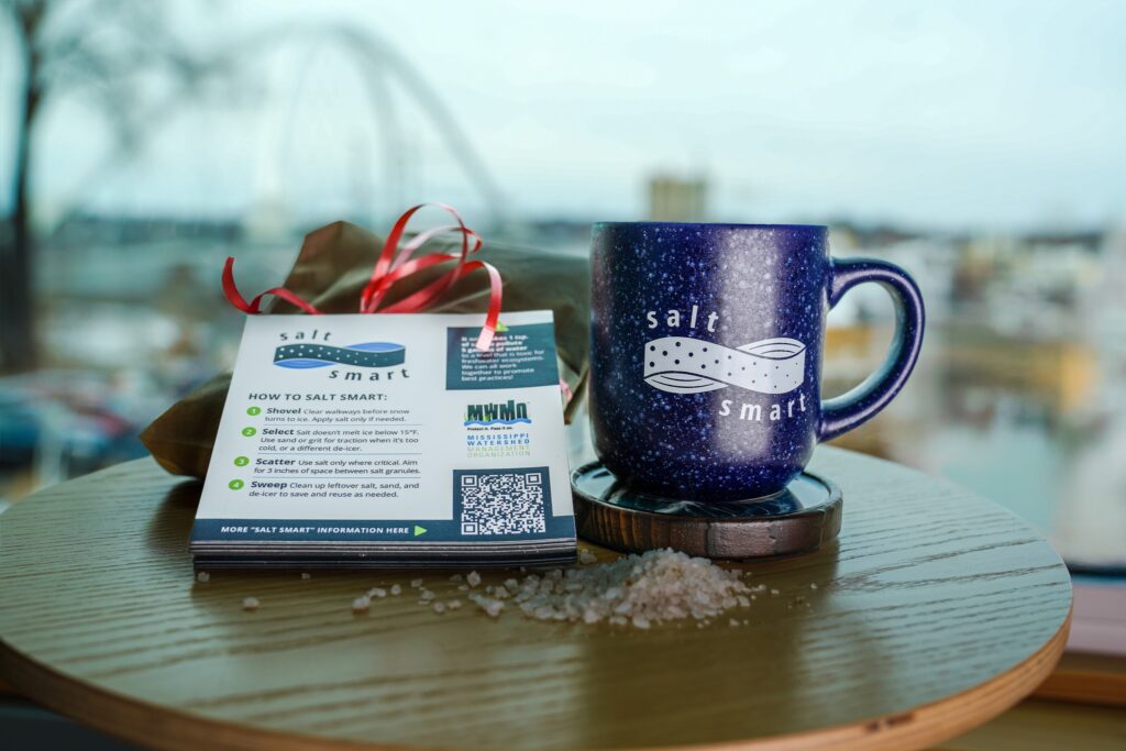 Winter Salt Week Smart Salting Mug Traction Grit and Magnets displayed on a table with loose rock salt